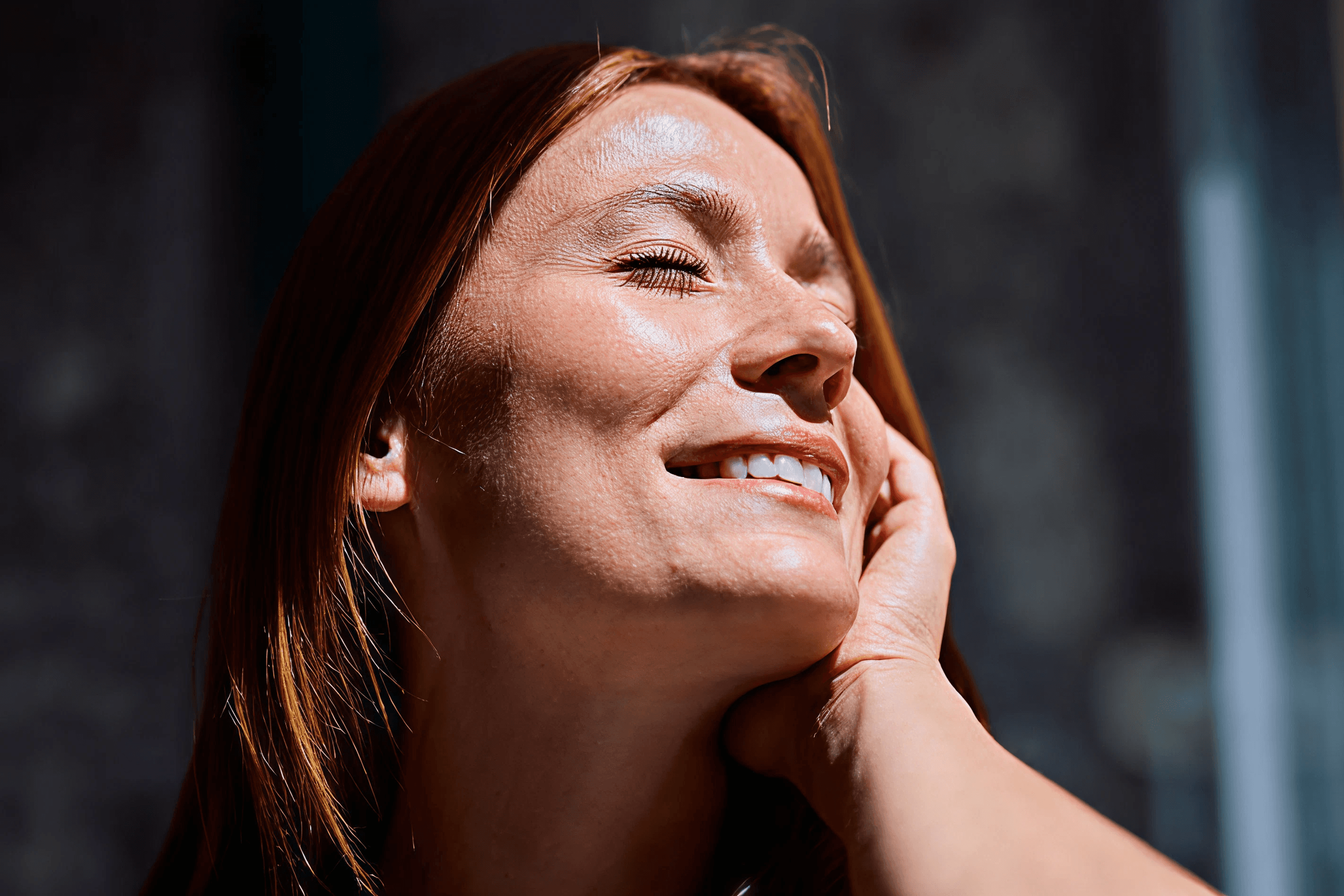 Woman smiling with her face to the sun